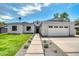 Charming single-Gathering home featuring well-manicured front yard, stone accents and a two-car garage on a sunny day at 4107 E Edgemont Ave, Phoenix, AZ 85008