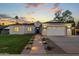 Charming home with manicured lawn, showcasing modern design, walkway lighting, and a welcoming ambiance at 4107 E Edgemont Ave, Phoenix, AZ 85008