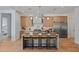 Modern kitchen boasts stainless appliances, center island, and stylish pendant lighting at 4107 E Edgemont Ave, Phoenix, AZ 85008