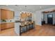 Modern kitchen features stainless appliances, an island with seating, and light wood cabinets at 4107 E Edgemont Ave, Phoenix, AZ 85008