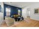 Chic living room with hardwood floors, a stylish navy accent wall and abundant natural light at 4107 E Edgemont Ave, Phoenix, AZ 85008