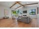 Bright living room features wood floors, wooden beams, fireplace and large windows at 4107 E Edgemont Ave, Phoenix, AZ 85008