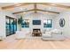 Bright, open living room with hardwood floors, beamed ceilings, and modern decor at 4107 E Edgemont Ave, Phoenix, AZ 85008