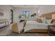 Sunlit bedroom with a cozy bed, decorative chairs, and serene backyard views at 4107 E Edgemont Ave, Phoenix, AZ 85008