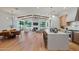 Open floor plan with kitchen island, living room with fireplace, and dining area with wood floors at 4107 E Edgemont Ave, Phoenix, AZ 85008