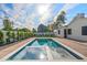 Inviting pool with blue tile accents, complemented by a well-maintained yard and a modern, neutral-toned home at 4107 E Edgemont Ave, Phoenix, AZ 85008