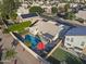 Suburban home with a sparkling pool, solar panels, and mature trees at 418 W Sagebrush St, Gilbert, AZ 85233