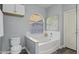 Bright bathroom with a large soaking tub under a window, providing a serene and relaxing atmosphere at 418 W Sagebrush St, Gilbert, AZ 85233