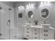 Bathroom featuring a double sink vanity, vessel sinks, stylish mirrors, and a glass-enclosed shower at 418 W Sagebrush St, Gilbert, AZ 85233