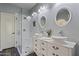 Elegant bathroom featuring a double sink vanity, vessel sinks, stylish mirrors, and a glass-enclosed shower at 418 W Sagebrush St, Gilbert, AZ 85233