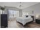 Bright bedroom with a ceiling fan, large window, and en-suite bath at 418 W Sagebrush St, Gilbert, AZ 85233