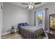 Well-lit bedroom with wood-look flooring and a large window for natural light at 418 W Sagebrush St, Gilbert, AZ 85233