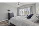 Bedroom features a ceiling fan, a large bed, and wood-look floors at 418 W Sagebrush St, Gilbert, AZ 85233