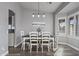Cozy dining room with a rustic table, white chairs, and plenty of natural light at 418 W Sagebrush St, Gilbert, AZ 85233