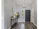 Inviting foyer with wood floors, stylish console table, mirror, and modern light fixture at 418 W Sagebrush St, Gilbert, AZ 85233