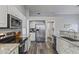 Modern kitchen with stainless steel appliances, granite countertops, and white cabinetry at 418 W Sagebrush St, Gilbert, AZ 85233