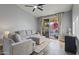 Comfortable living room with a large sectional sofa, ceiling fan, and sliding glass doors at 418 W Sagebrush St, Gilbert, AZ 85233