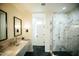 Sleek bathroom featuring a dual vanity, marble countertops, modern fixtures, and a glass enclosed shower at 419 W 11Th St, Tempe, AZ 85281