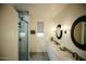 Bright bathroom featuring a dual marble vanity and tiled glass enclosed shower at 419 W 11Th St, Tempe, AZ 85281