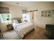 Bright bedroom featuring hardwood floors, a comfortable bed, neutral tones, and an adjacent bathroom at 419 W 11Th St, Tempe, AZ 85281