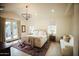 Bright bedroom with a chandelier, French doors and neutral color palette at 419 W 11Th St, Tempe, AZ 85281