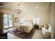 Spacious bedroom featuring soft neutral tones, a sitting area, a plush bed, and lots of natural light at 419 W 11Th St, Tempe, AZ 85281