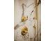 Detailed shot of the shower with golden fixtures and white marble walls at 419 W 11Th St, Tempe, AZ 85281