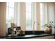 Counter with modern fixtures and accessories complemented by natural light streaming through the large windows at 419 W 11Th St, Tempe, AZ 85281