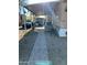 View of the front entrance with covered patio, parking, and small storage shed at 4211 W Roosevelt St # 235, Phoenix, AZ 85009