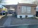 Exterior view of a charming mobile home with a covered front patio area at 4211 W Roosevelt St # 235, Phoenix, AZ 85009