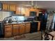 The kitchen features wood cabinets, black appliances, and laminate countertops at 4211 W Roosevelt St # 235, Phoenix, AZ 85009