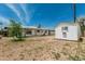 Wide view of a backyard featuring a detached shed and low maintenance desert landscaping at 4531 N 12Th Dr, Phoenix, AZ 85013