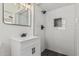 Bathroom features modern vanity, black fixtures, and walk-in shower with black honeycomb tile at 4531 N 12Th Dr, Phoenix, AZ 85013