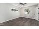 Bright, empty bedroom with wood-look floors and ample natural light from two windows at 4531 N 12Th Dr, Phoenix, AZ 85013