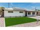 Inviting single-story home with a well-maintained lawn and modern solar panels on the roof at 4531 N 12Th Dr, Phoenix, AZ 85013