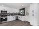 Updated kitchen boasting stainless steel appliances, white cabinetry, and dark backsplash at 4531 N 12Th Dr, Phoenix, AZ 85013