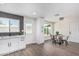 Bright kitchen features white cabinets, black backsplash, and an adjacent dining area at 4531 N 12Th Dr, Phoenix, AZ 85013
