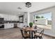 Modern kitchen and dining area featuring sleek countertops, white cabinets, and a view to back yard at 4531 N 12Th Dr, Phoenix, AZ 85013