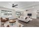 Inviting living room with hardwood floors, a modern ceiling fan, and an abundance of natural light at 4531 N 12Th Dr, Phoenix, AZ 85013