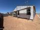 Back exterior of home being constructed showing framework, vapor barrier, and scaffolding, plus lot grading at 47720 W Kenner Dr, Maricopa, AZ 85139