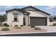 Beautiful single story home featuring a two-car garage and neutral colored stone landscaping at 47720 W Kenner Dr, Maricopa, AZ 85139