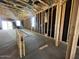 Unfinished living room featuring bare studs, concrete floors, and natural light streaming through windows at 47720 W Kenner Dr, Maricopa, AZ 85139