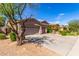 Single-story home featuring a three-car garage, complemented by mature trees at 492 E Vermont Dr, Gilbert, AZ 85295