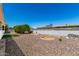 Spacious backyard featuring gravel, artificial turf, decorative rocks, and a well-maintained perimeter wall at 5122 E Emerald Cir, Mesa, AZ 85206
