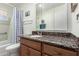 Functional bathroom featuring granite vanity, mirrored cabinet, and shower/tub combo at 5122 E Emerald Cir, Mesa, AZ 85206