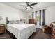 Relaxing bedroom showcasing a comfortable bed, ceiling fan, and natural light from the window at 5122 E Emerald Cir, Mesa, AZ 85206