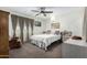 Bright bedroom with a ceiling fan, side tables and natural light, great for relaxation at 5122 E Emerald Cir, Mesa, AZ 85206