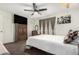 Serene bedroom featuring a ceiling fan, window, and ample closet space for organized storage at 5122 E Emerald Cir, Mesa, AZ 85206