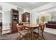Dining area with classic wood table set and matching display cabinets for storage at 5122 E Emerald Cir, Mesa, AZ 85206