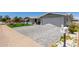 Well-maintained home featuring a brick-paved driveway and lush landscaping, offering great curb appeal at 5122 E Emerald Cir, Mesa, AZ 85206